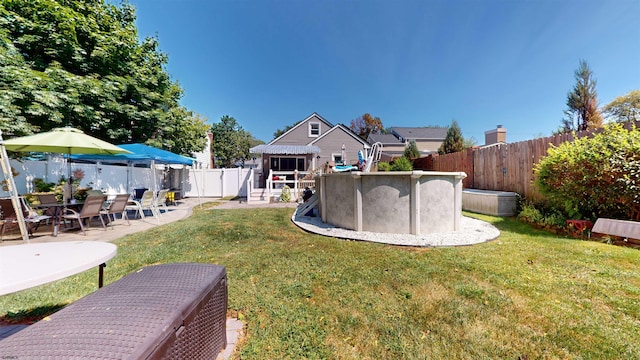 view of yard with a fenced in pool and a patio area