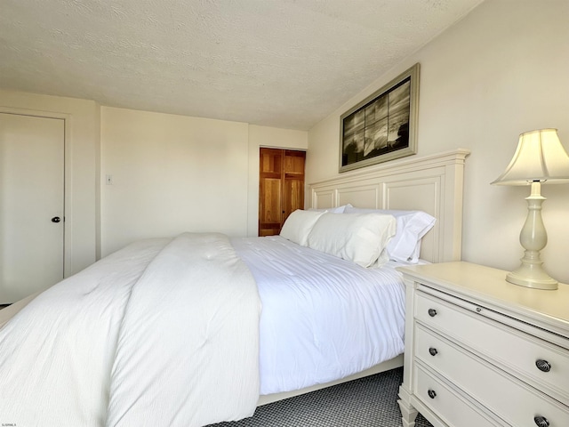 bedroom with a closet and a textured ceiling