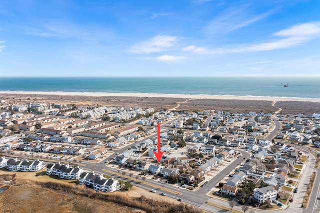 aerial view with a water view and a view of the beach