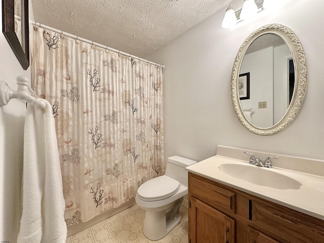 bathroom with vanity, toilet, and a textured ceiling