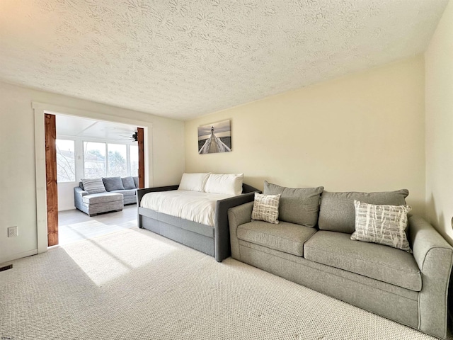 living room with light carpet and a textured ceiling