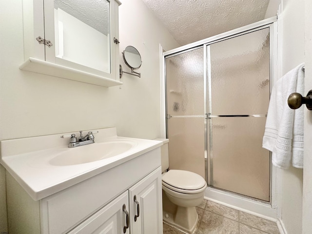 bathroom with vanity, an enclosed shower, a textured ceiling, and toilet