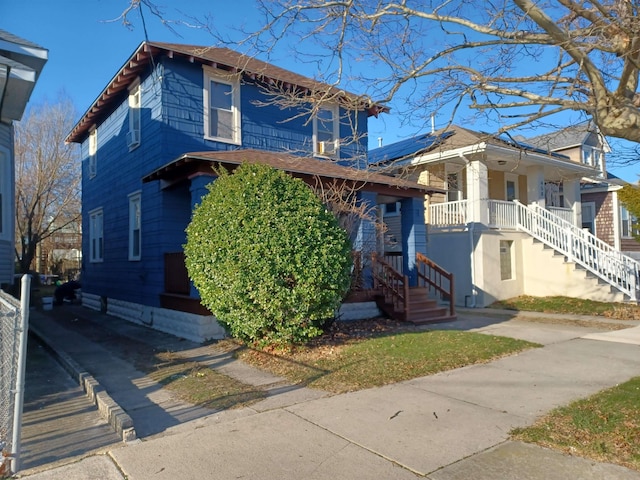 view of front of property featuring solar panels