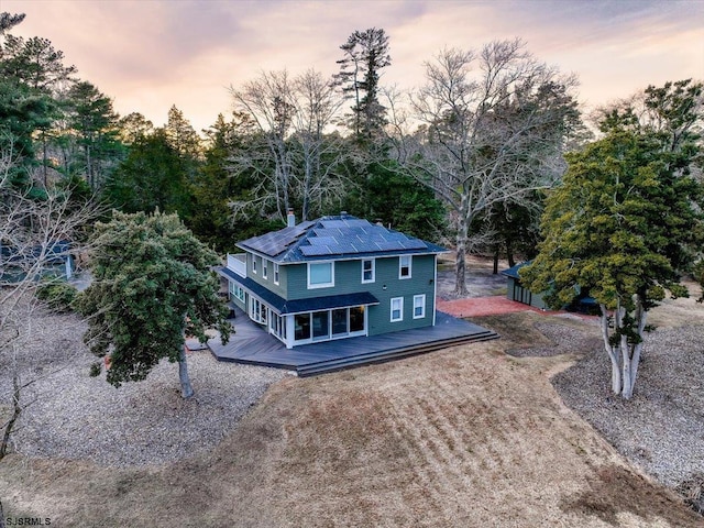 exterior space featuring solar panels and a deck