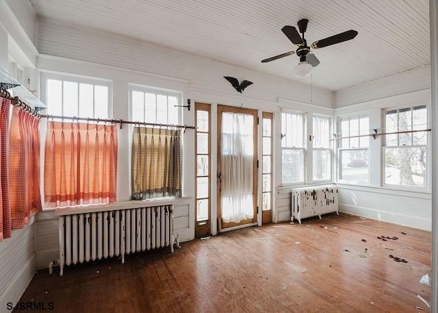 sunroom / solarium with radiator heating unit and ceiling fan