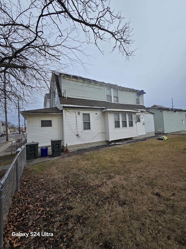 rear view of house with a lawn