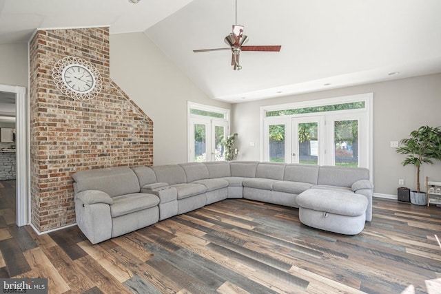 living room with brick wall, high vaulted ceiling, ceiling fan, dark wood-type flooring, and french doors