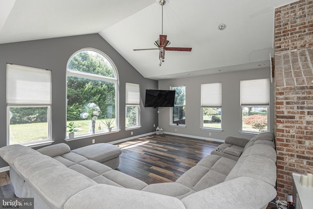 living room featuring lofted ceiling, dark hardwood / wood-style flooring, and a healthy amount of sunlight