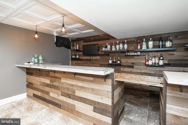 bar with pendant lighting and wooden walls