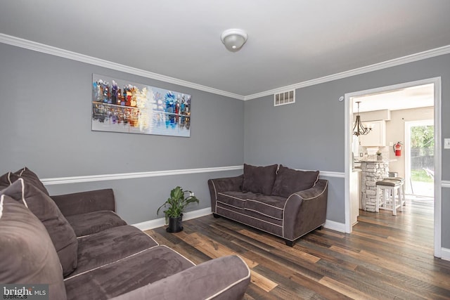 living room with dark wood-type flooring and crown molding