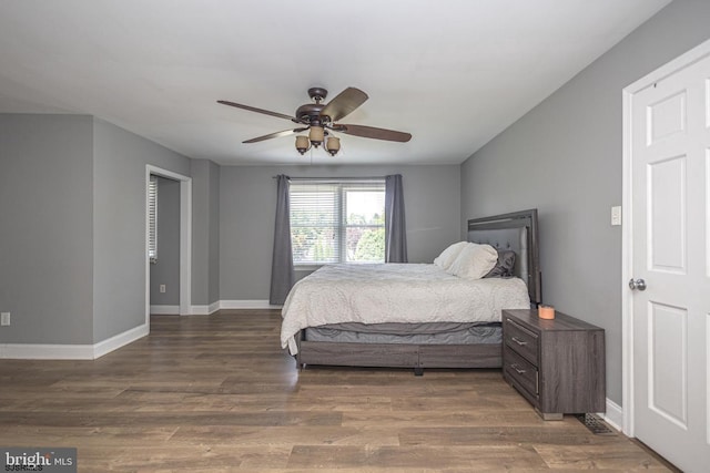 bedroom featuring ceiling fan and dark hardwood / wood-style flooring