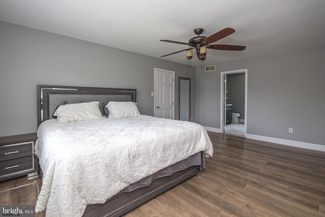 bedroom featuring ceiling fan, dark hardwood / wood-style floors, and ensuite bath