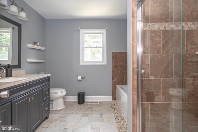 full bathroom with vanity, toilet, and separate shower and tub