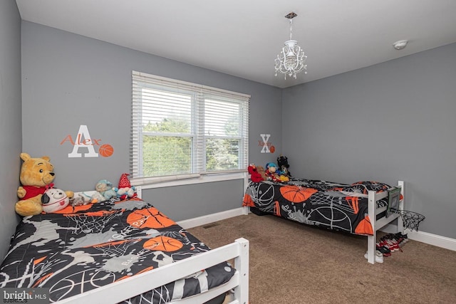 carpeted bedroom with an inviting chandelier