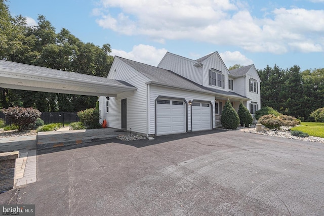 view of front of home featuring a garage and a carport