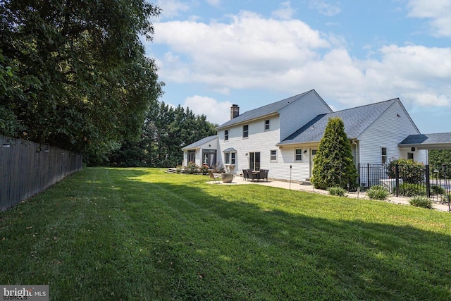 exterior space with a patio and a lawn