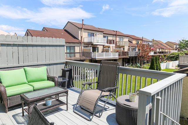 deck featuring an outdoor hangout area and a lawn