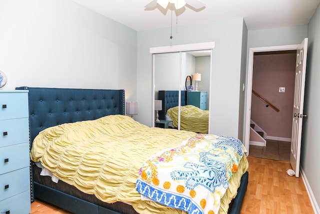 bedroom with hardwood / wood-style floors, a closet, and ceiling fan