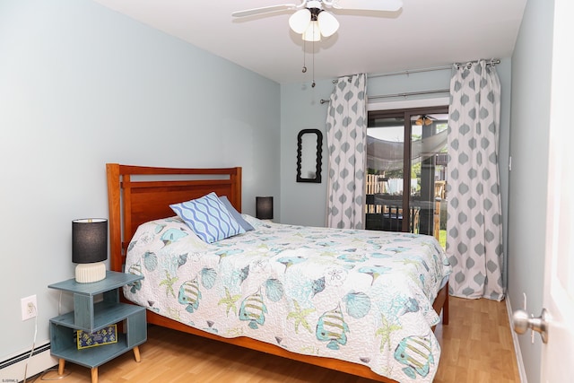 bedroom featuring hardwood / wood-style floors, ceiling fan, access to outside, and baseboard heating