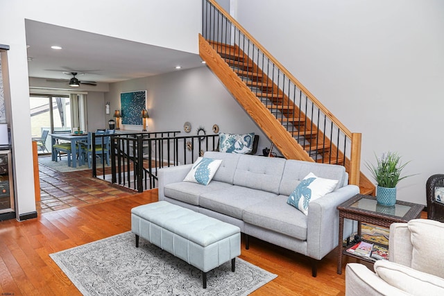 living room featuring hardwood / wood-style floors and ceiling fan