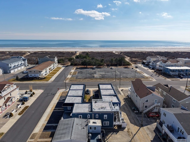 drone / aerial view with a beach view and a water view