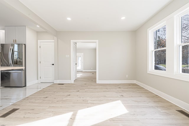 unfurnished dining area with light hardwood / wood-style flooring