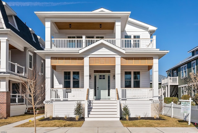 view of front facade with a balcony and covered porch