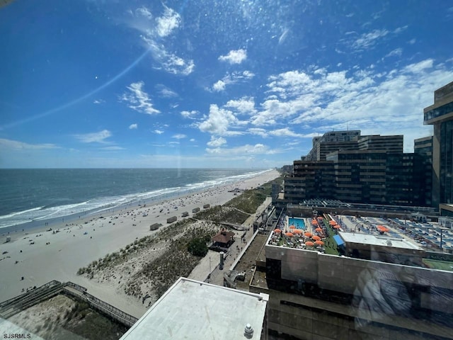 drone / aerial view with a water view and a view of the beach