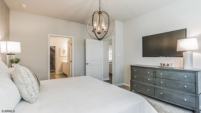 bedroom featuring connected bathroom and an inviting chandelier