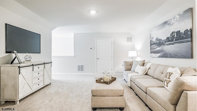 living room featuring lofted ceiling and light colored carpet