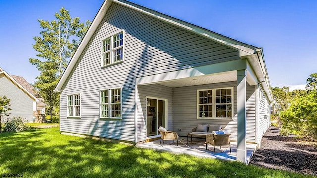 back of property featuring a yard and a patio area