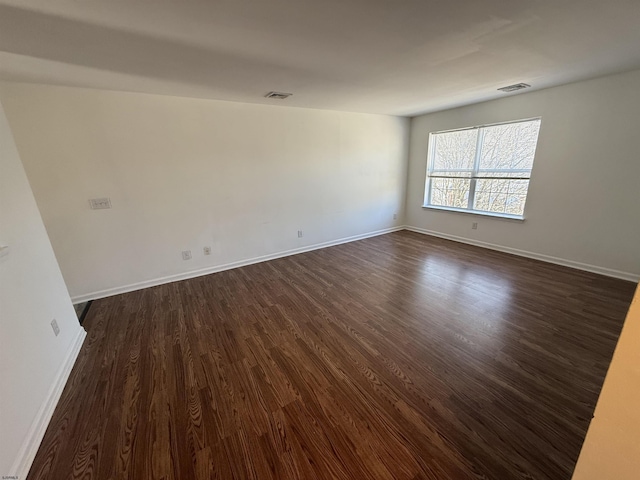 spare room featuring dark hardwood / wood-style flooring