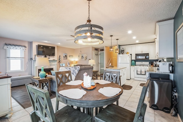 dining space featuring light tile patterned floors and a textured ceiling