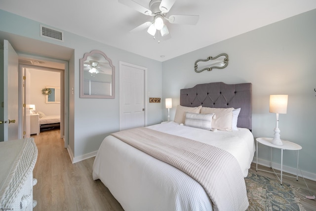 bedroom with ceiling fan and light hardwood / wood-style floors