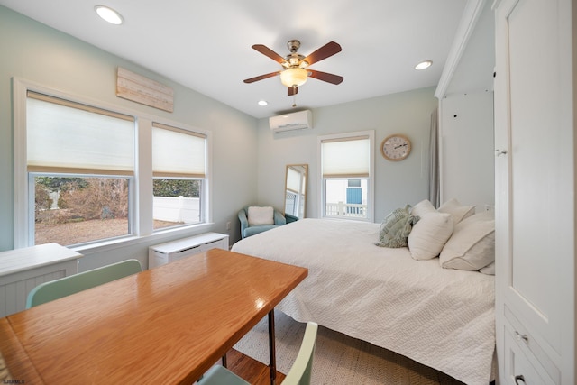 bedroom with an AC wall unit and ceiling fan