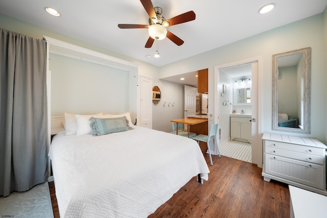 bedroom with ceiling fan, connected bathroom, and dark hardwood / wood-style floors