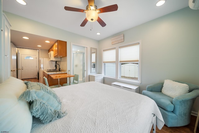 bedroom with sink, hardwood / wood-style floors, an AC wall unit, and ceiling fan