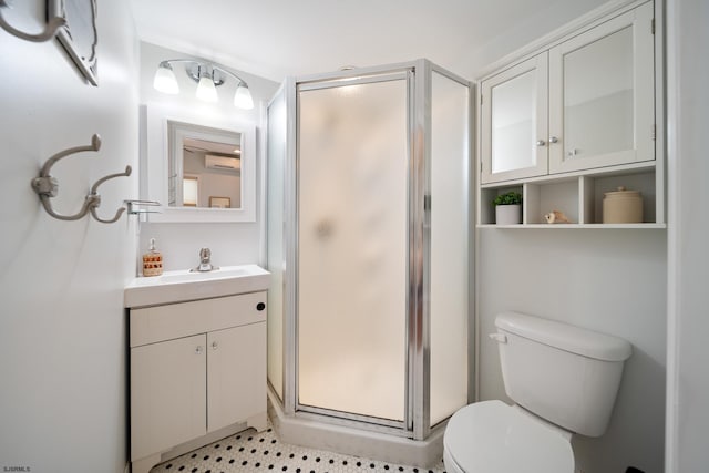 bathroom with vanity, a wall unit AC, toilet, and walk in shower