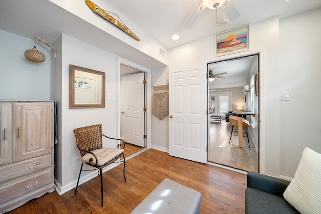 sitting room with ceiling fan and hardwood / wood-style floors