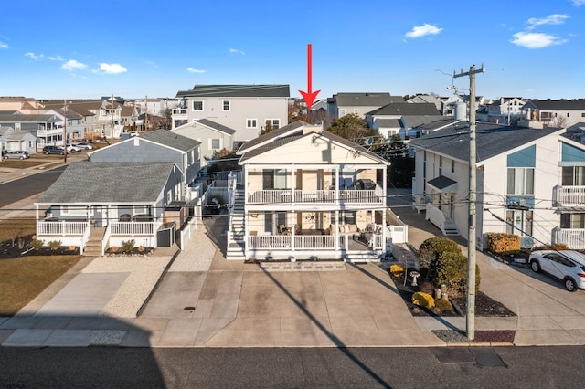 view of front of property featuring a balcony and covered porch