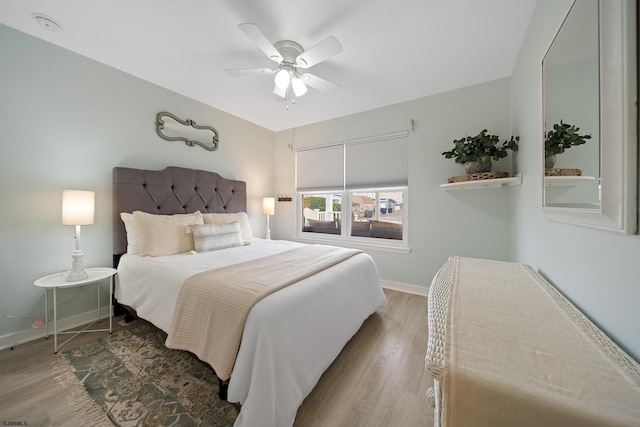 bedroom with hardwood / wood-style floors and ceiling fan