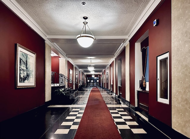 interior space featuring ornamental molding and a textured ceiling