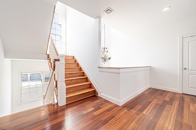 stairs with hardwood / wood-style floors