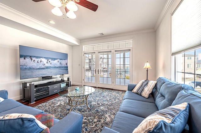 living room featuring dark hardwood / wood-style flooring, crown molding, french doors, and ceiling fan