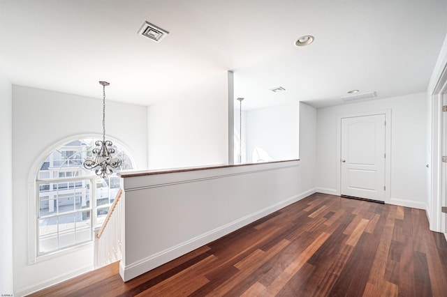 interior space with dark hardwood / wood-style flooring and a notable chandelier