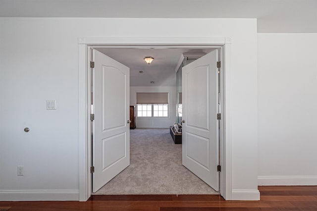 corridor with light hardwood / wood-style floors