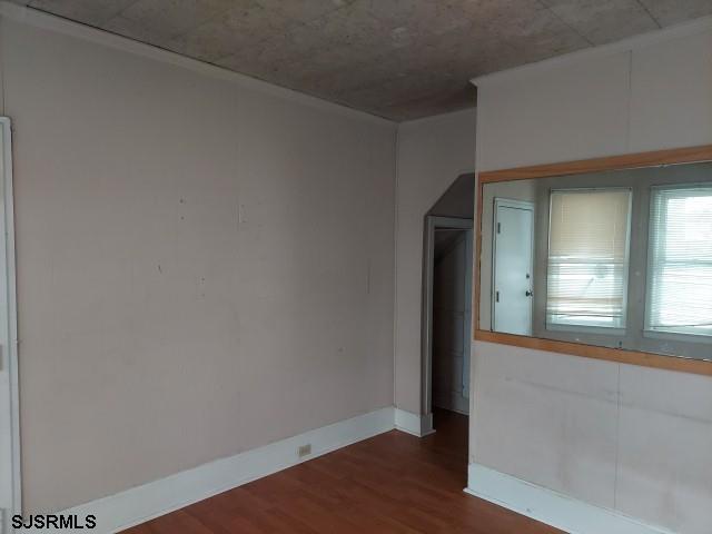 unfurnished room with dark hardwood / wood-style floors