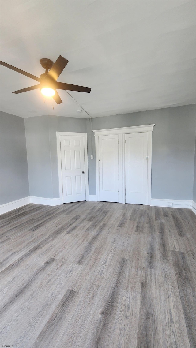 unfurnished bedroom featuring ceiling fan and light hardwood / wood-style flooring