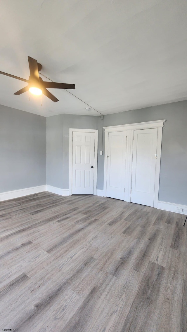 unfurnished bedroom with light hardwood / wood-style floors and ceiling fan