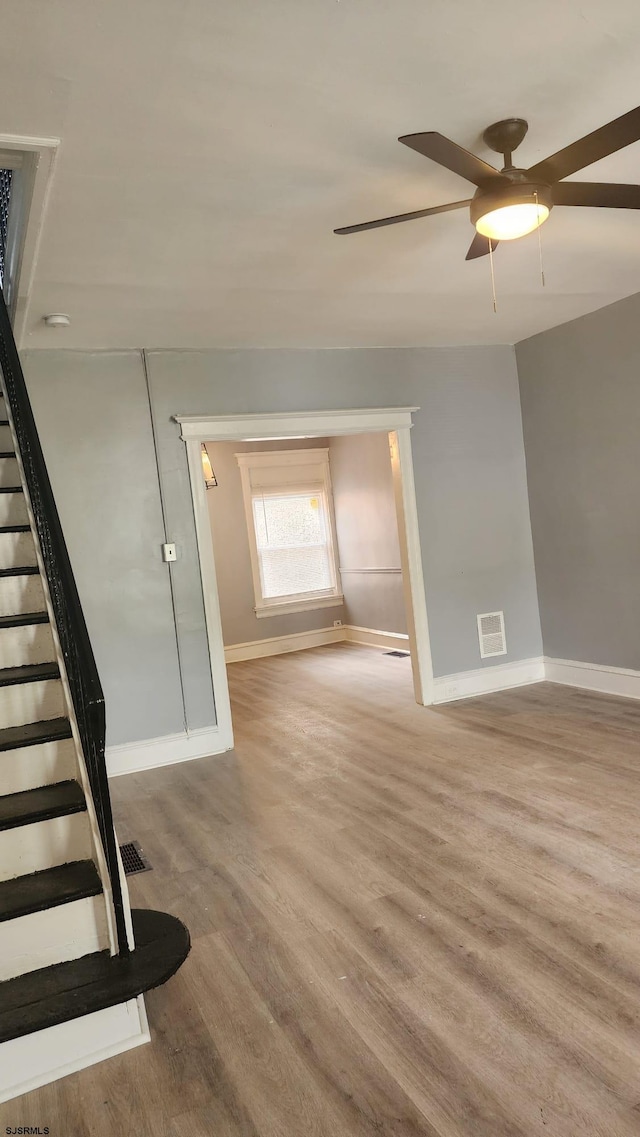 unfurnished room with ceiling fan and light hardwood / wood-style floors